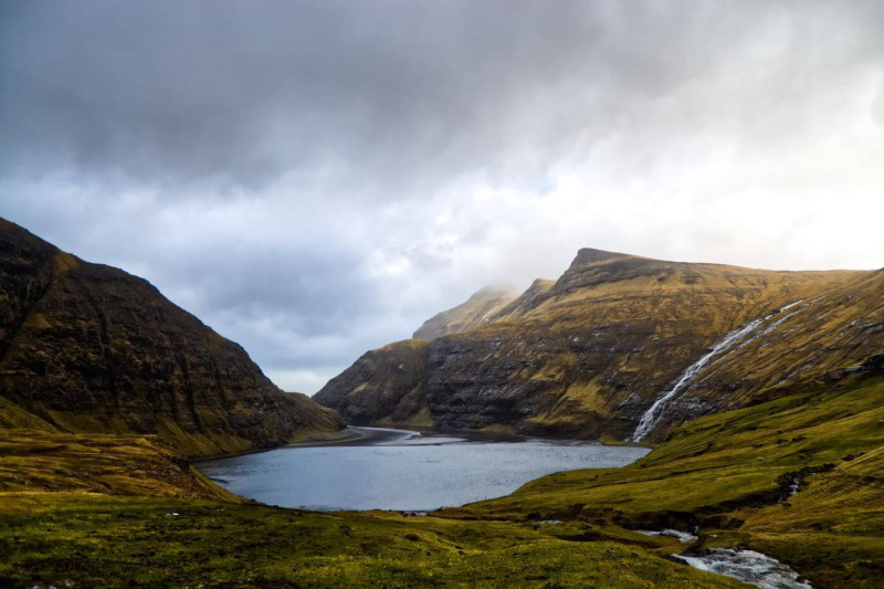 Lake with a waterfall, surrounded by mountains